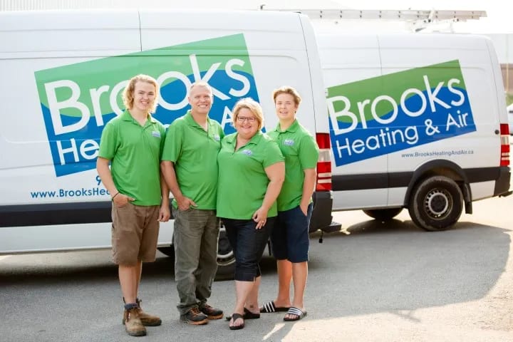 The Brooks family in front of a branded Brooks Heating & Air service van in Georgetown, Ontario