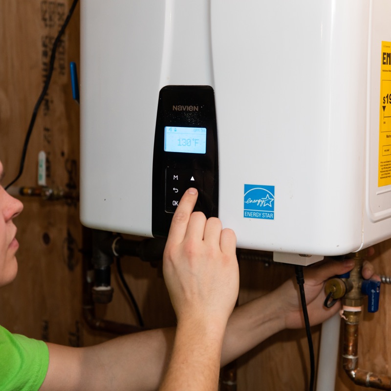 Brooks technician servicing a tankless water heater