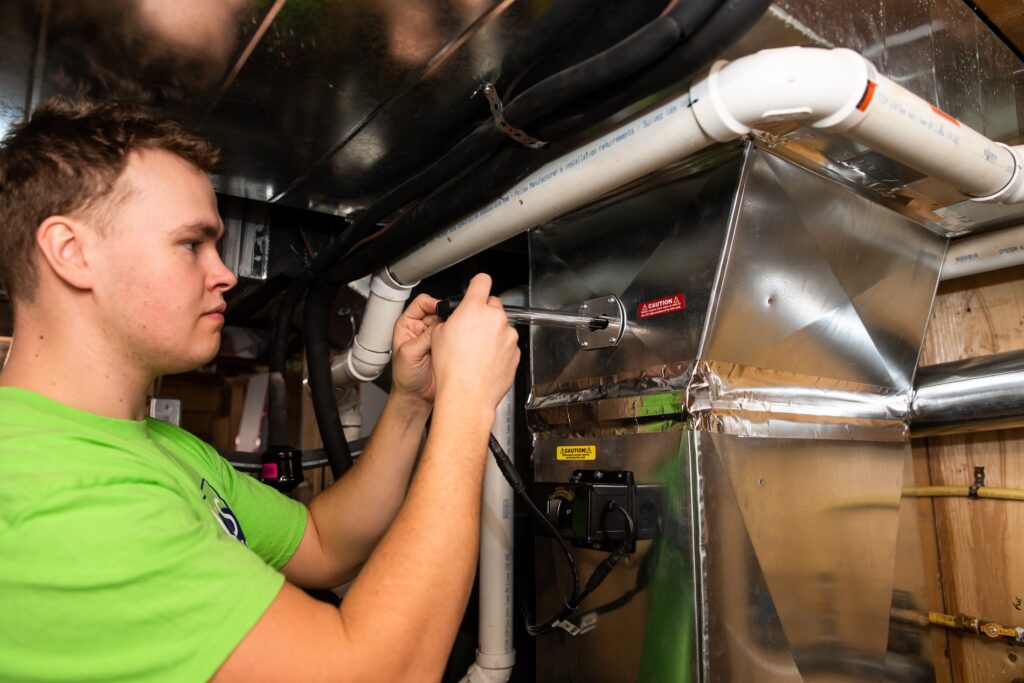 A professional technician repairing Furnace System